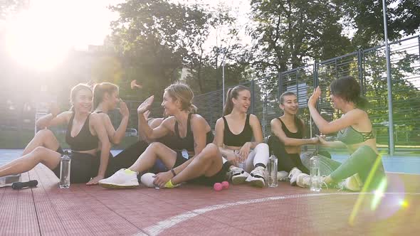 Sporty Slim Women Resting After Fitness Lesson and Giving Each Other High Five