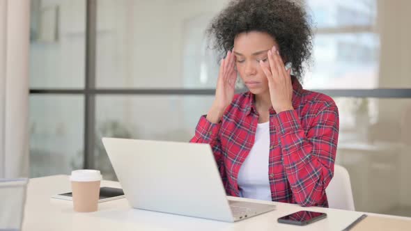 African Woman Having Headache While Working on Laptop