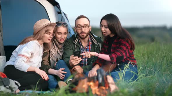 Group of People Use Smartphone Together Discussing and Pointing