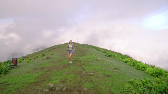 the girl walks on tops of mountains. Amazing atmospheric moment