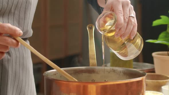 Crop woman preparing risotto in kitchen