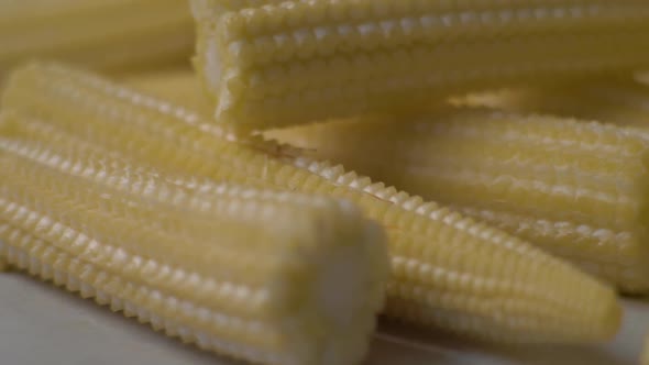 Fresh Corns Lie on the Table. . Food Video. Close-up of Fresh Corn. Concept: Footage for the Recipe