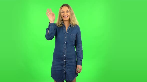 Fair Woman Is Waving Hand and Showing Gesture Come Here. Green Screen