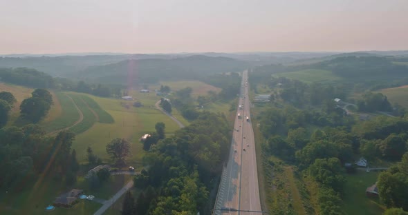 In Pennsylvania US an Aerial View Shows a Highway 70 Near Small Town Village Behind Trees and Hills