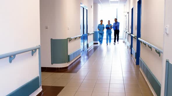 Doctor and nurses discussing over clipboard