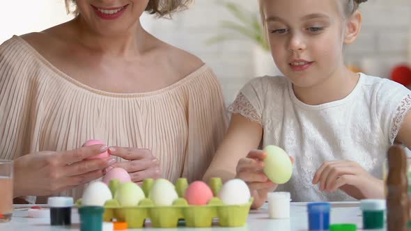 Mother and Kid Packing Dyed Ester Eggs in Box, Giving High-Five to Each Other