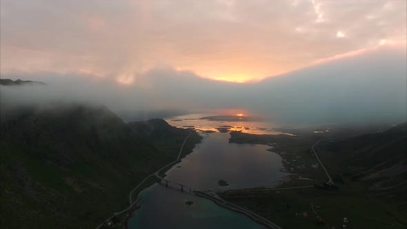 Flying above the clouds with midnight sun on Lofoten