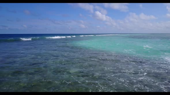 Aerial drone view panorama of idyllic seashore beach lifestyle by shallow lagoon and white sand back