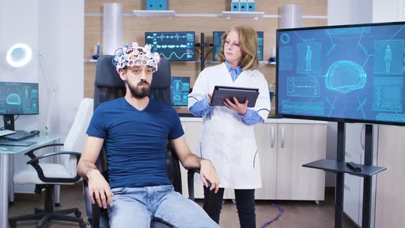 Female Doctor Checking the Brain Activity of Male Patient