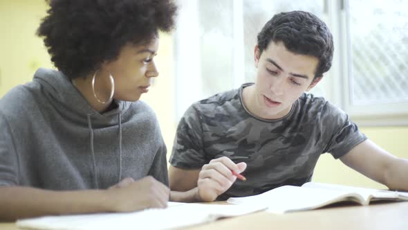 Teenage friends studying together in the classroom