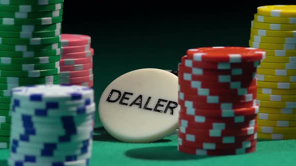 A large number of chips lying on green gambling table, throwing dice in slow-mo