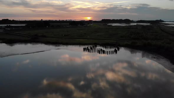 reflection of clouds during sunset at a fresh water tidal area in the Netherlands