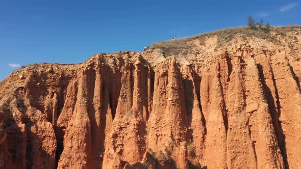 The Drone Flies Over Red Rocks On A Sunny Day With A Clear Blue Sky In National Park