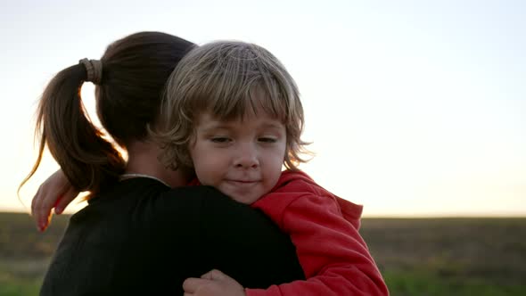 Loving Smiling Son Hugs Mom Tightly