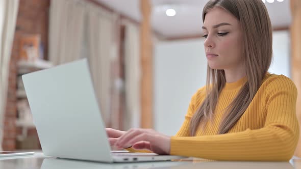 Ambitious Young Woman Working on Laptop