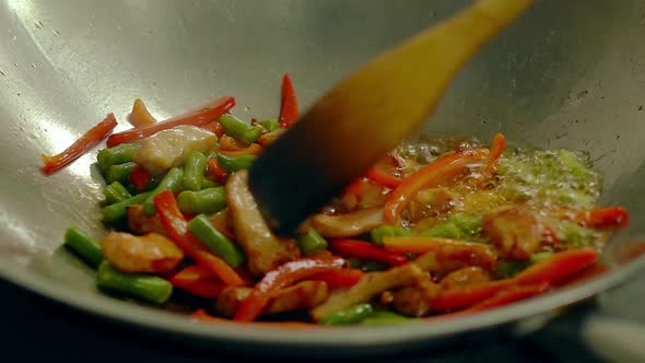 Cook Prepares in a Frying Pan, in Oil, with Fresh Vegetables - Potatoes, Tomatoes, Green Beans