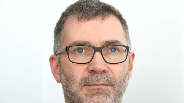 Closeup Portrait of Senior Man with Blue Eyes and Grey Beard on White Wall Background Fathers Day