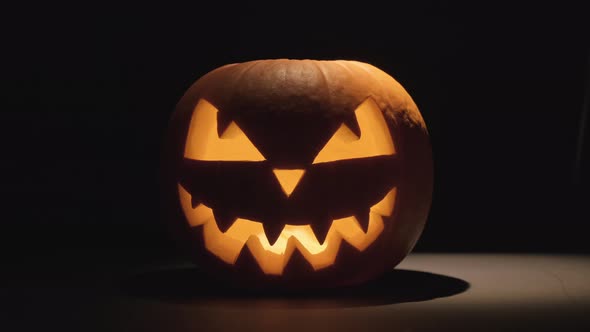 Pumpkin Glows on Halloween Night. Traditional Halloween Symbol.