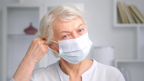 Serious aged lady with short grey hairstyle