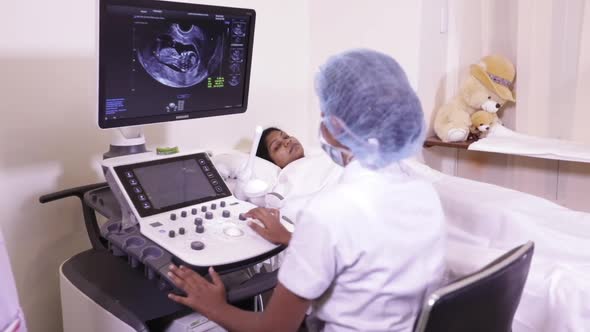 Indian Mother And Ultrasound Operator Viewing Her Fetus 2