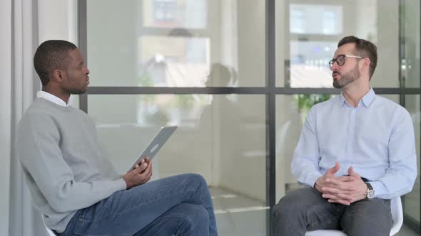 African Businessman with Tablet Interviewing Businessman