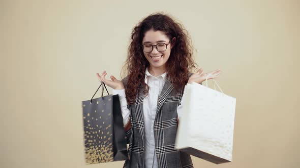 Delighted Young Woman She Holds Many Cardboard Bags in Her Hand Satisfied with the Purchases Made