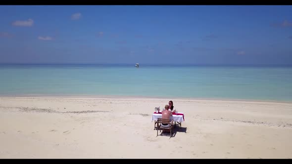 Teenage lovers relax on tranquil resort beach time by blue water and clean sand background of the Ma