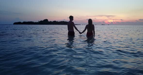 Romantic boy and girl in love dating on vacation spend quality time on beach on summer white sandy 