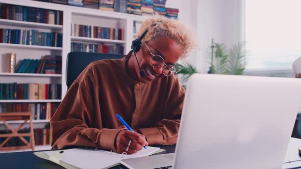 Smiling African Woman in Headset with Mic Holding Web Camera Video Call Meeting
