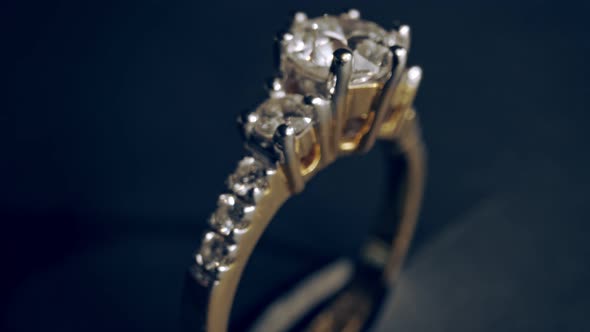 Extreme detailed of diamond ring close up shot while rotating on dark background