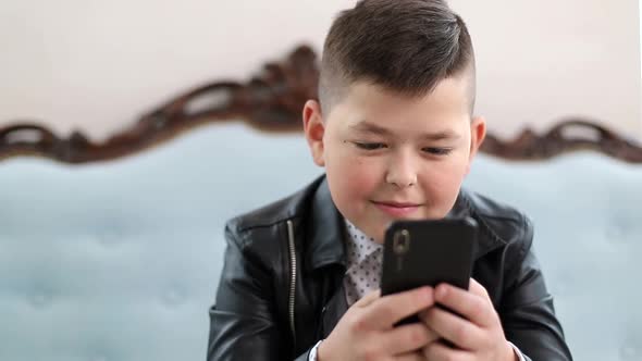 Little Schoolboy Talking on a Smartphone