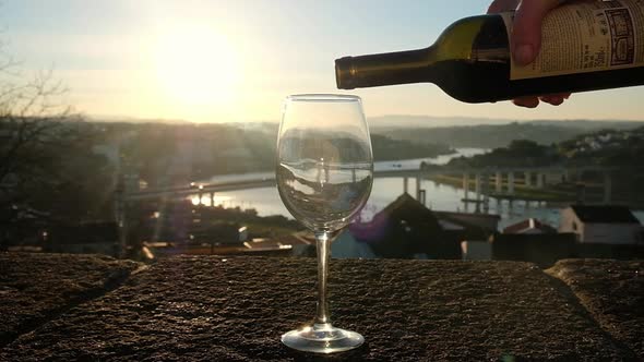 The Red Wine is Poured to the Transparent Glass