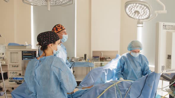 Male Surgeon Preforming Operation Uterus Removal in Hospital Operating Theater