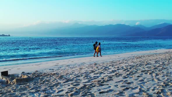 Ladies happy together on exotic bay beach vacation by turquoise sea and white sand background of Bal