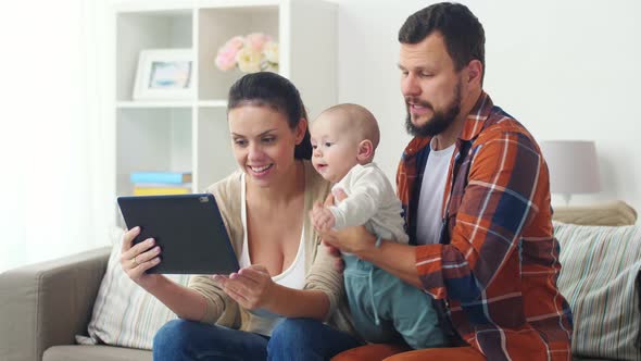 Mother, Father and Baby with Tablet Pc at Home