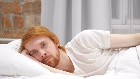 Young Redhead Beard Man Lying in Bed