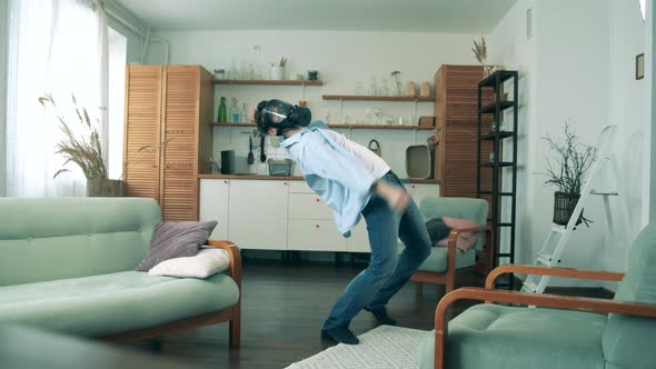 A Man in a Hazmat Mask Is Dancing in a Flat During Pandemic of Coronavirus, Covid-19.