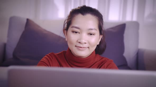 Businesswoman on redshirt using the laptop for meeting online and work from home in coronavirus