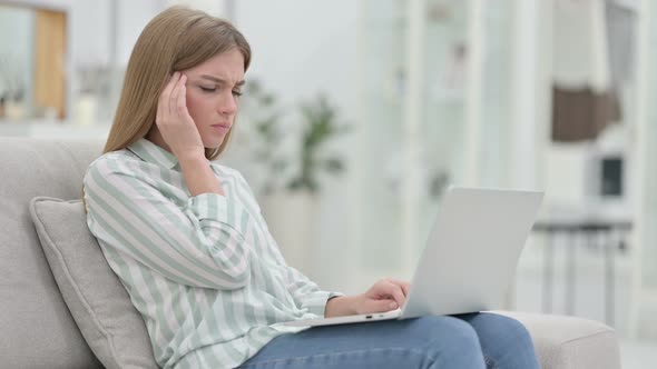 Stressed Young Woman with Laptop Having Headache at Home 