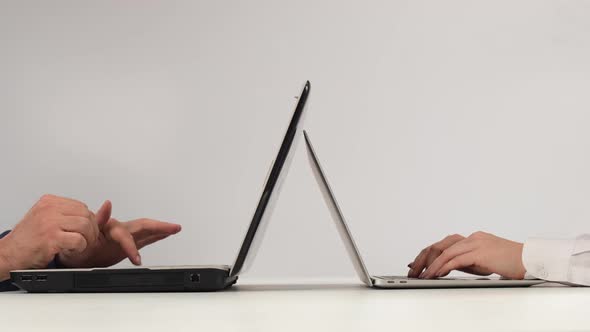 Man and Woman Work on Laptops on a White Background