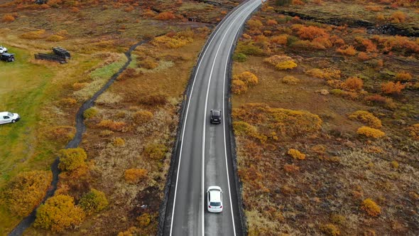 Aerial View of Car Driving Along Road in an Autumn Landscape Iceland National Park Thingvellir