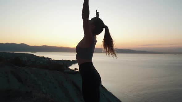 Silhouette of Woman Doing Stretching at Early Morning in Ray of Sun, Slow Motion