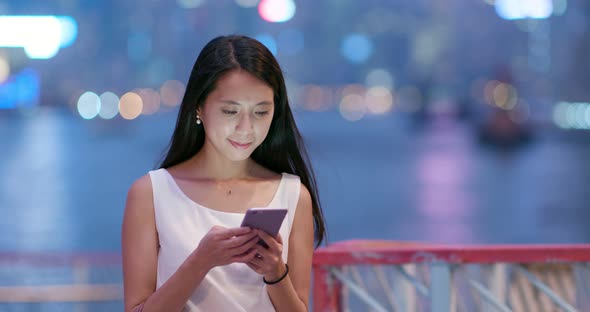 Woman check on cellphone at night