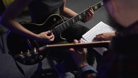 Young Beautiful Girl in Lesson with Experienced Guitarist in Studio