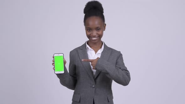Young Happy African Businesswoman Showing Phone and Giving Thumbs Up