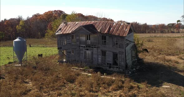 Abandoned antique farm house with drone video pull out.