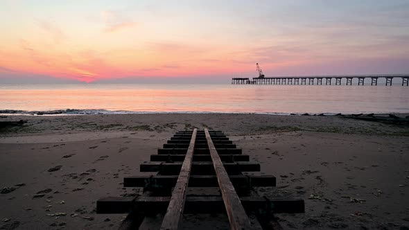 Video with colorful close up view of a sandy beach at sunrise