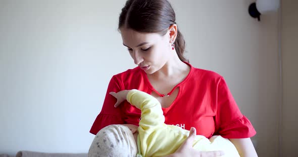 Mother Breastfeeding Baby at Home