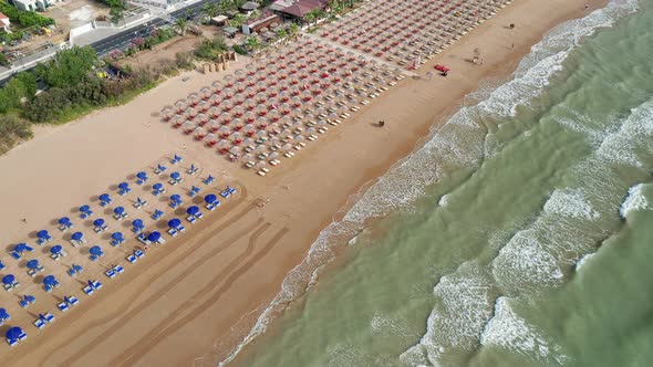 Aerial view of amazing beach with colorful umbrellas