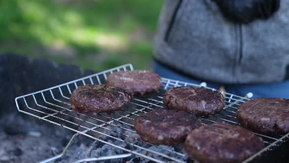 Woman Flips Burger Beef Minced Cutlets Cooking on Charcoal Grill